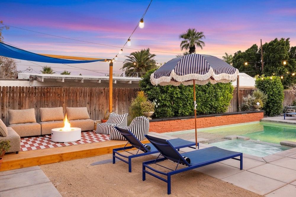 A private pool and lounge chairs at our Palm Springs guest unit, at dusk